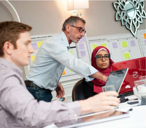 3 people looking at computer screen